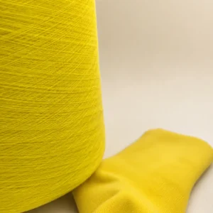 Sợi cotton chải thô màu vàng dùng cho vớ Cone sợi cotton màu vàng đặt cạnh vớ dệt kim màu vàng