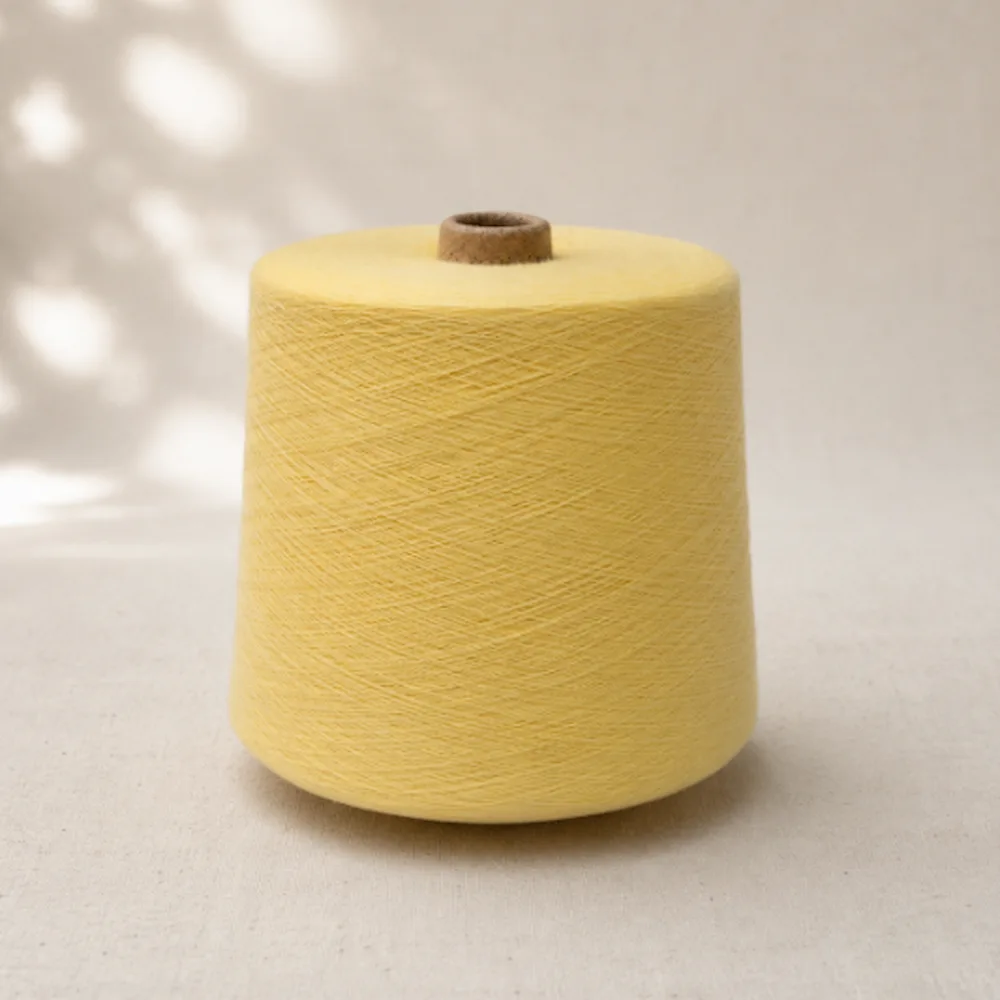 Sợi cotton chải kỹ nhuộm màu vàng nhạt dạng cone, cho dệt kim và dệt thoi