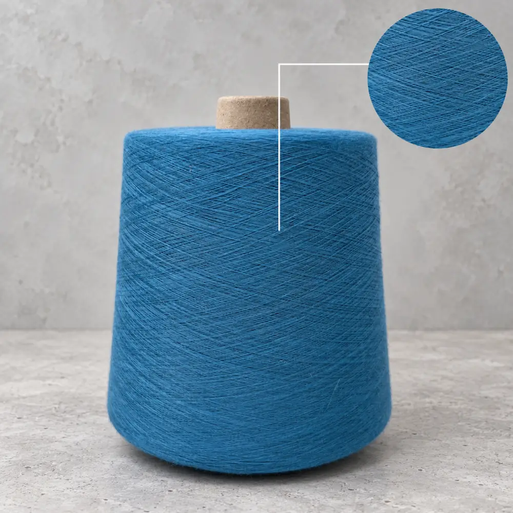 Cuộn sợi cotton hữu cơ tái chế màu xanh dương với chi tiết phóng lớn bề mặt sợi